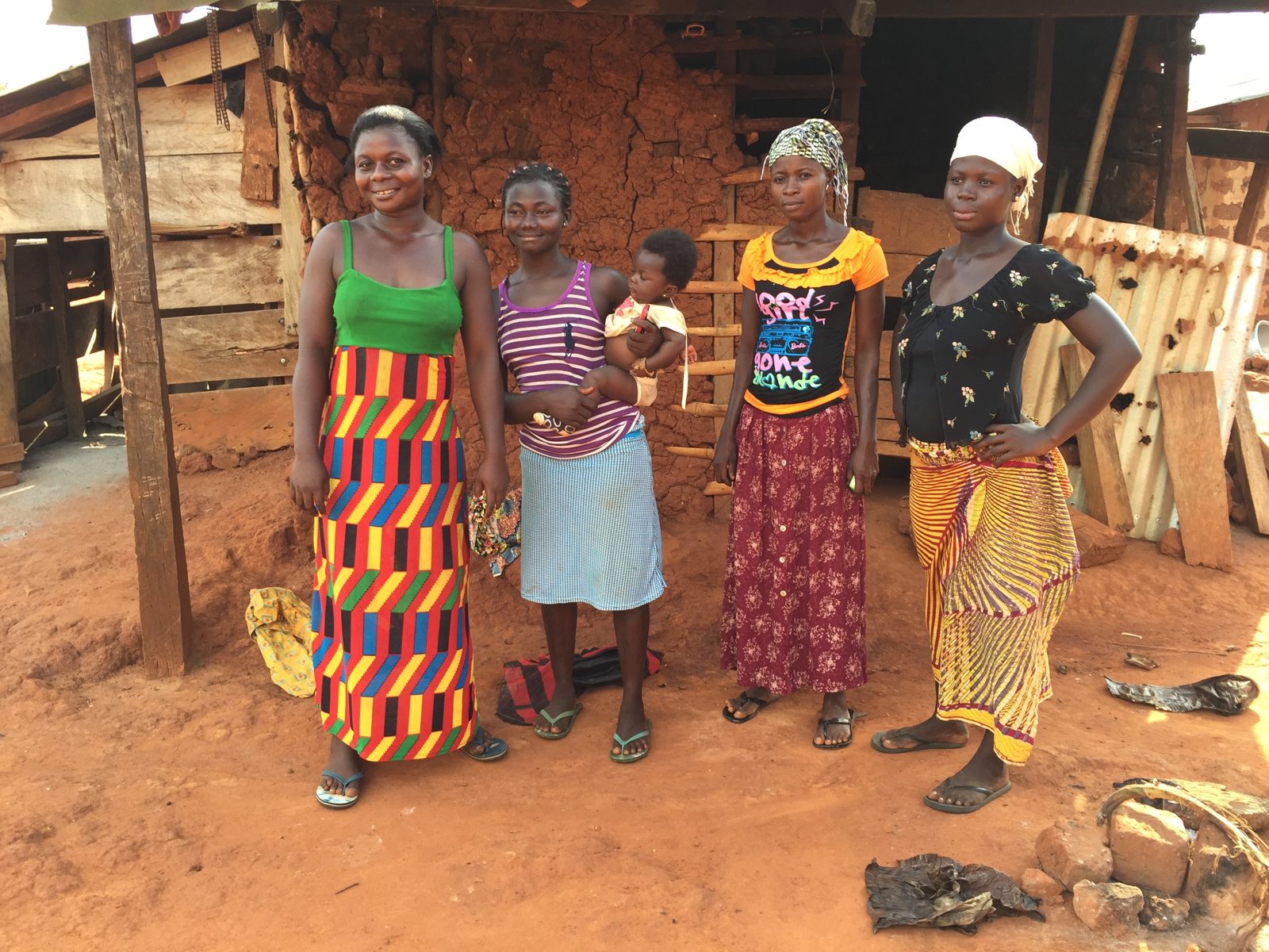 Women and children gathered outside their homes